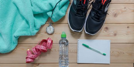 towel, stopwatch, shoes, water bottle, measuring tape, paper, pen